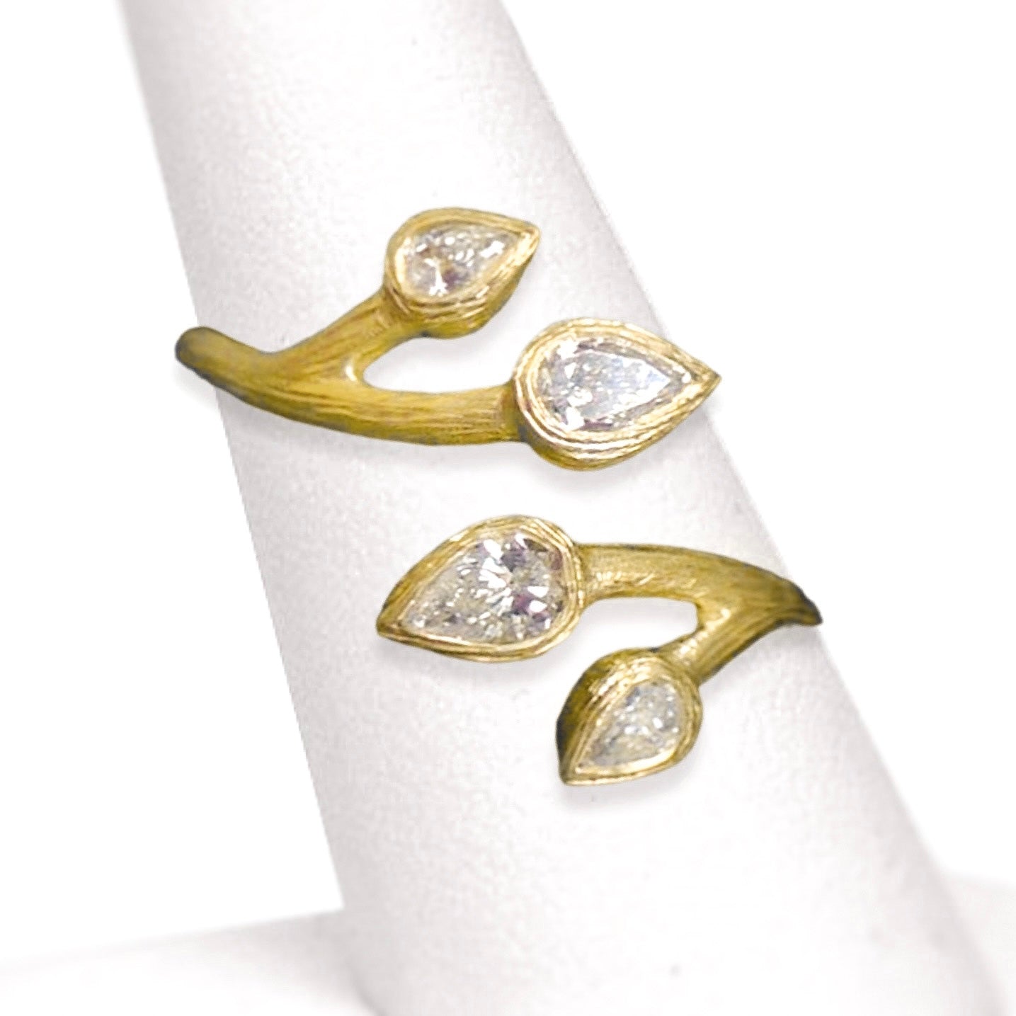 Pear Diamond Wrap Ring by Laurie Kaiser available at Talisman Collection Fine Jewelers in El Dorado Hills, CA and online. 0.31 carats of pear-cut diamonds sit like buds on an 18k yellow gold branch that wraps around your finger. This modern organic design makes an excellent choice for an alternative wedding band or right hand ring. Its fresh beauty will be treasured for years to come.