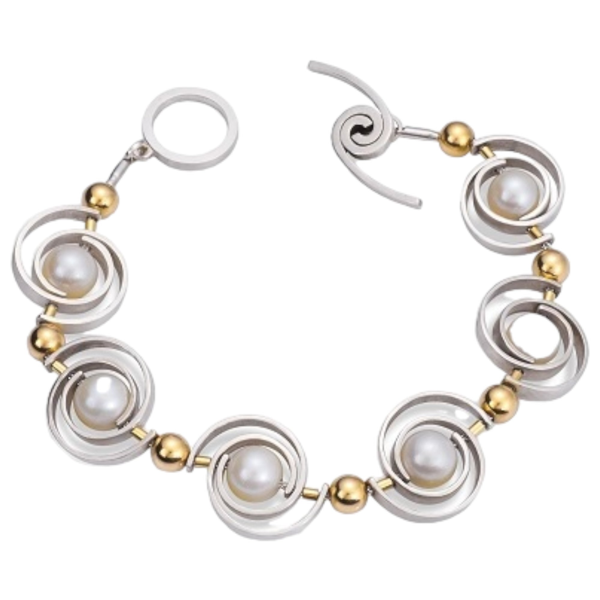 Orbit Articulating 2-tone Bracelet by Martha Seely available at Talisman Collection Fine Jewelers in El Dorado Hills, CA and online. Stats: Take your style to the next level with this stunning bracelet featuring large spirals in Argentium silver. Adorned with elegant white pearls and bold 14K beads, it's a piece that will catch everyone's eye. With its WINDSWEPT toggle, this bracelet also offers a secure and comfortable fit.