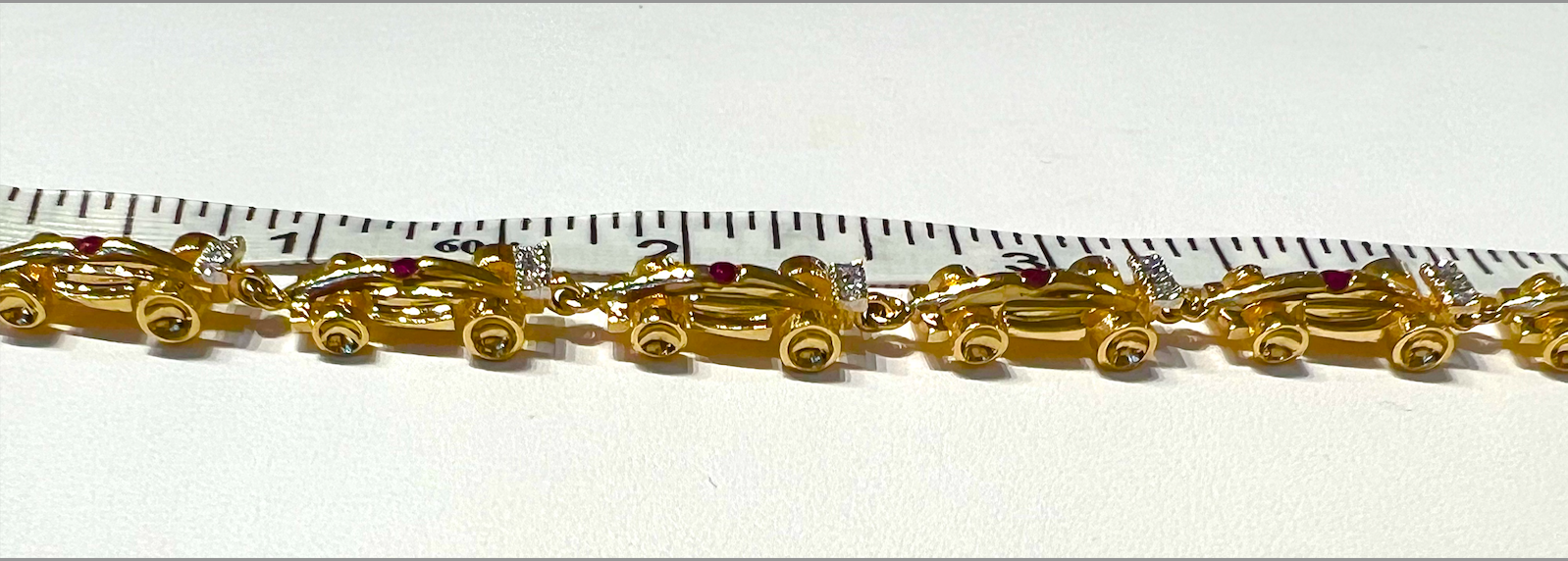 Gold Formula One Race Car Bracelet with Rubies and Diamonds