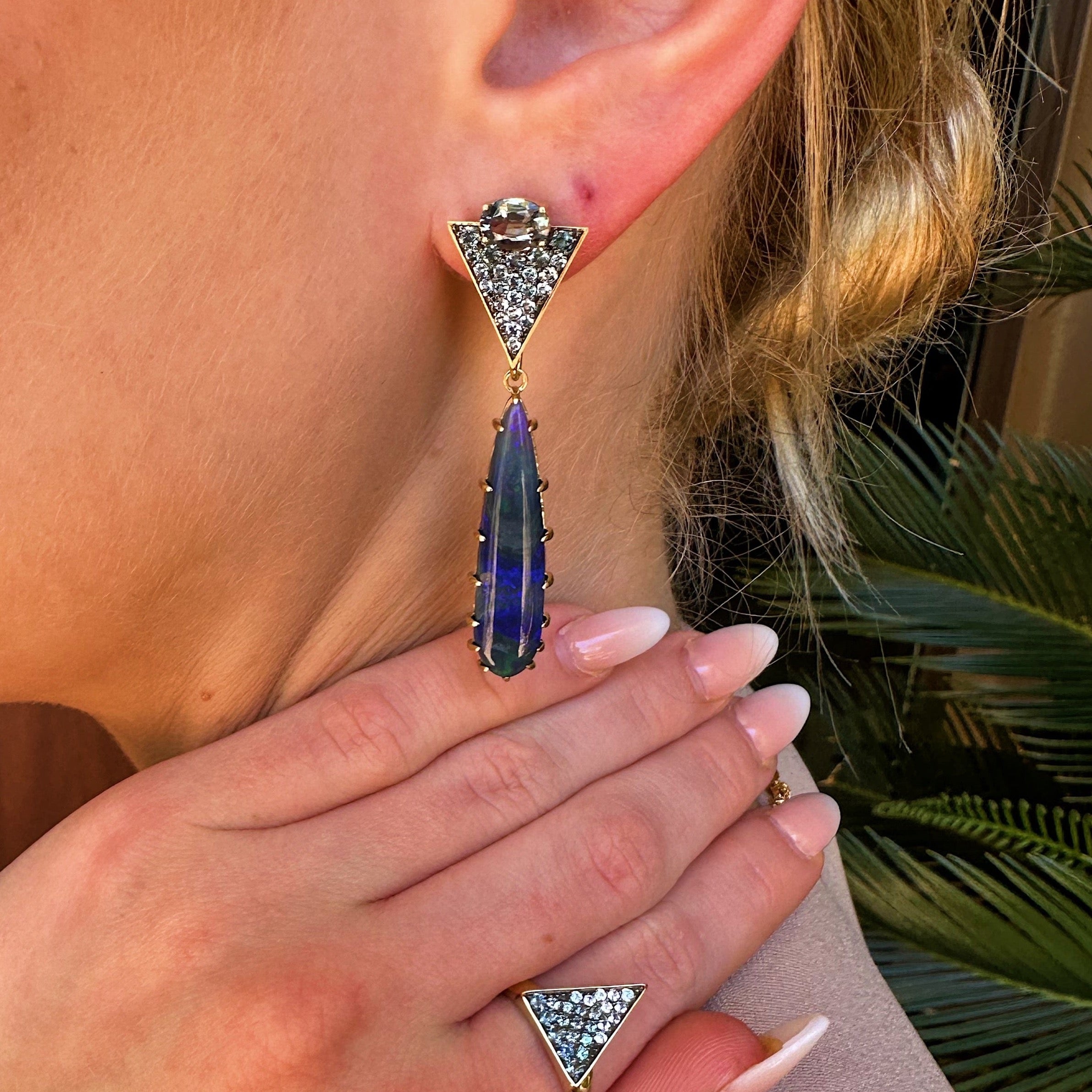 Orion’s Opal Earrings by Meredith Young available at Talisman Collection Fine Jewelers in El Dorado Hills, CA and online. A stellar combination of gemstones, Orion’s Opal Earrings are out of this world. The pave triangle tops feature 1.52 cts of gray spinels, .35 cts of denim spinel, and .6 cts of color-change garnets. Suspended below, dreamy, elongated, pear-cut opal drops hang like stars in the night sky. With classic post backs, these earrings are both comfortable and offer a touch of cosmic wonder.