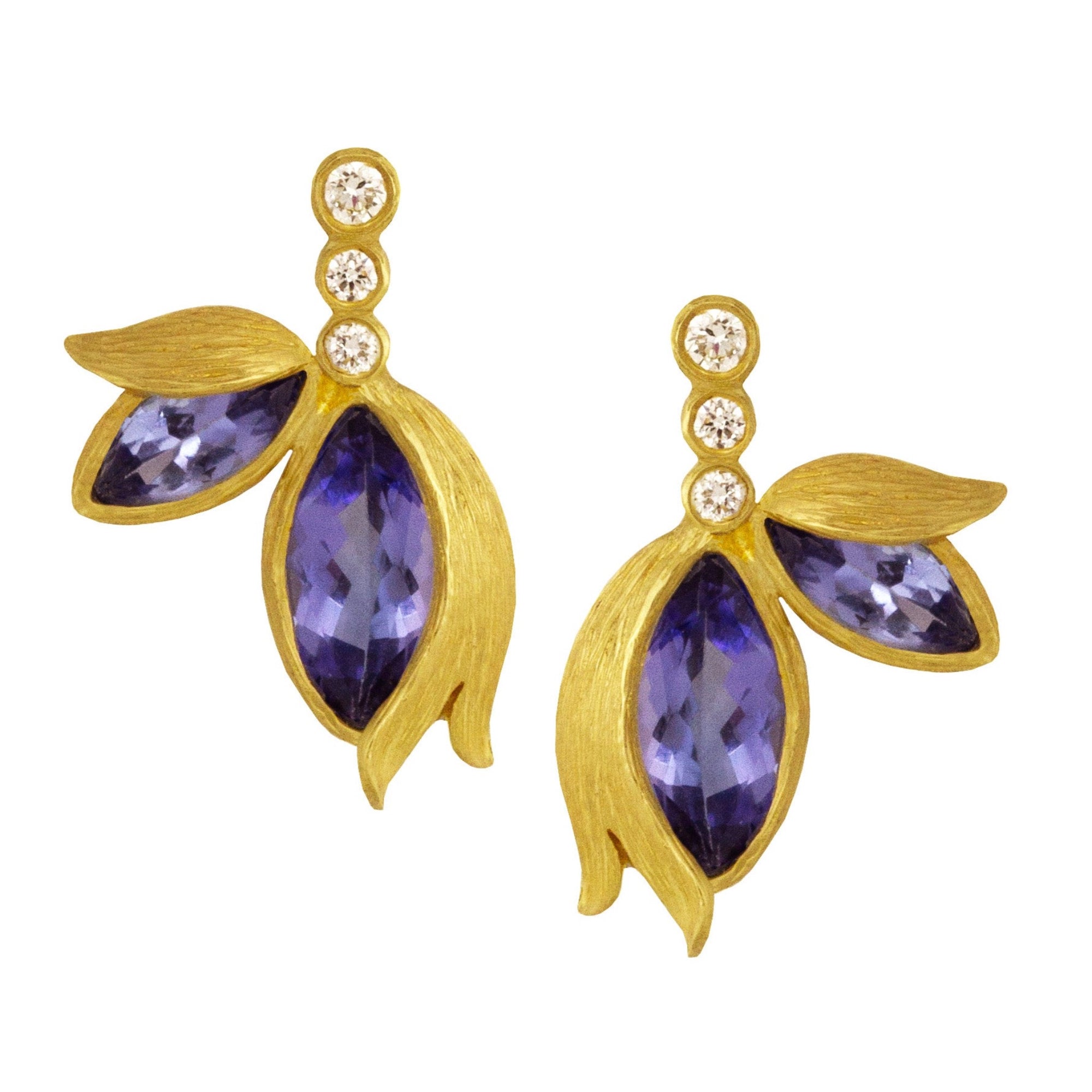 Tanzanite Double Petal Studs by Laurie Kaiser available at Talisman Collection Fine Jewelers in El Dorado Hills, CA and online. Delicately crafted with marquise-cut faceted tanzanites, 0.08 cts of white brilliant diamonds, and 18k yellow gold, the Tanzanite Double Petal Stud Earrings are both lovely and feminine.They will add the perfect little touch of luxury. 