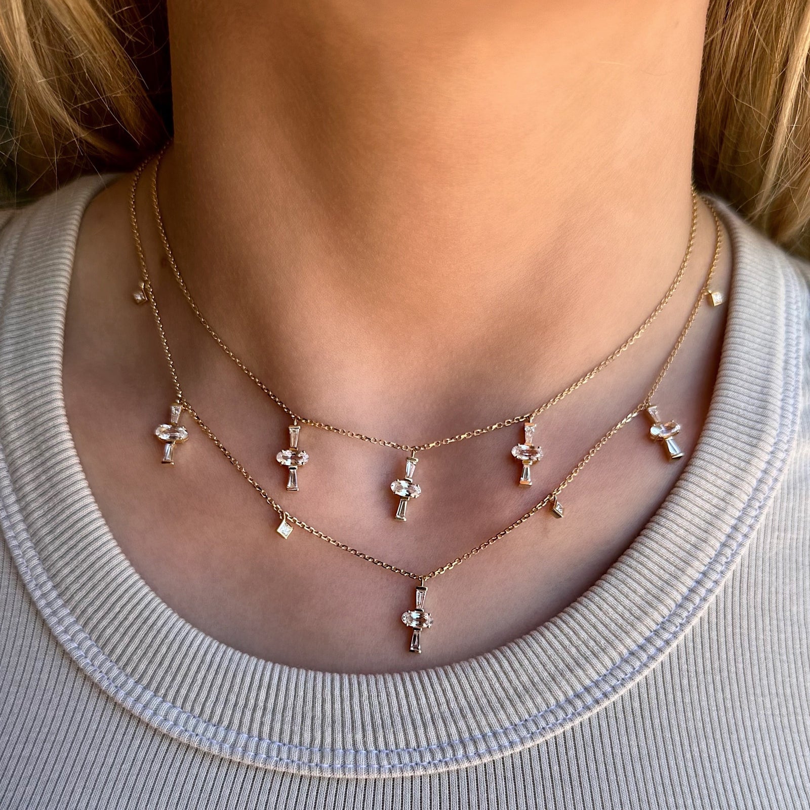 Three Charm Necklace by Meredith Young, available at Talisman Collection Fine Jewelers in El Dorado Hills, CA and online. Three times really is a charm! A delightful trio of oval-cut sapphires, totaling 1.5 carats, accompanied by .41 carats of tapered diamond baguettes dangle from a delicate 18k gold chain. This necklace offers an adjustable length, ranging from 18 to 20 inches, ensuring it's a perfect fit not matter your neckline.