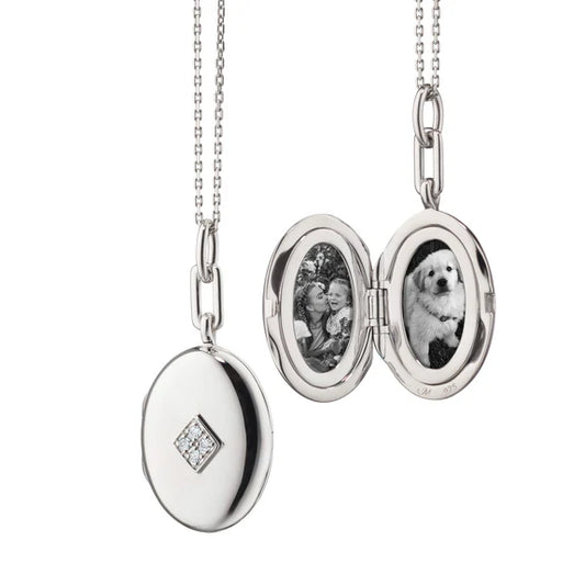 Silver Oval Locket with Diamonds by Monica Rich Kosann available at Talisman Collection Fine Jewelers in El Dorado Hills, CA and online. This sterling silver locket tells your story with a refined sparkle. Featuring pave-set white diamonds in a diamond-shaped pattern (.05 cts of FG/VS2 diamonds), the oval locket is finished with rhodium for lasting shine and protection from tarnishing. Measuring 1.5" tall and 1" wide, it hangs on an 18" silver mini diamond-cut chain with adjustable loops at 17” and 16” for 