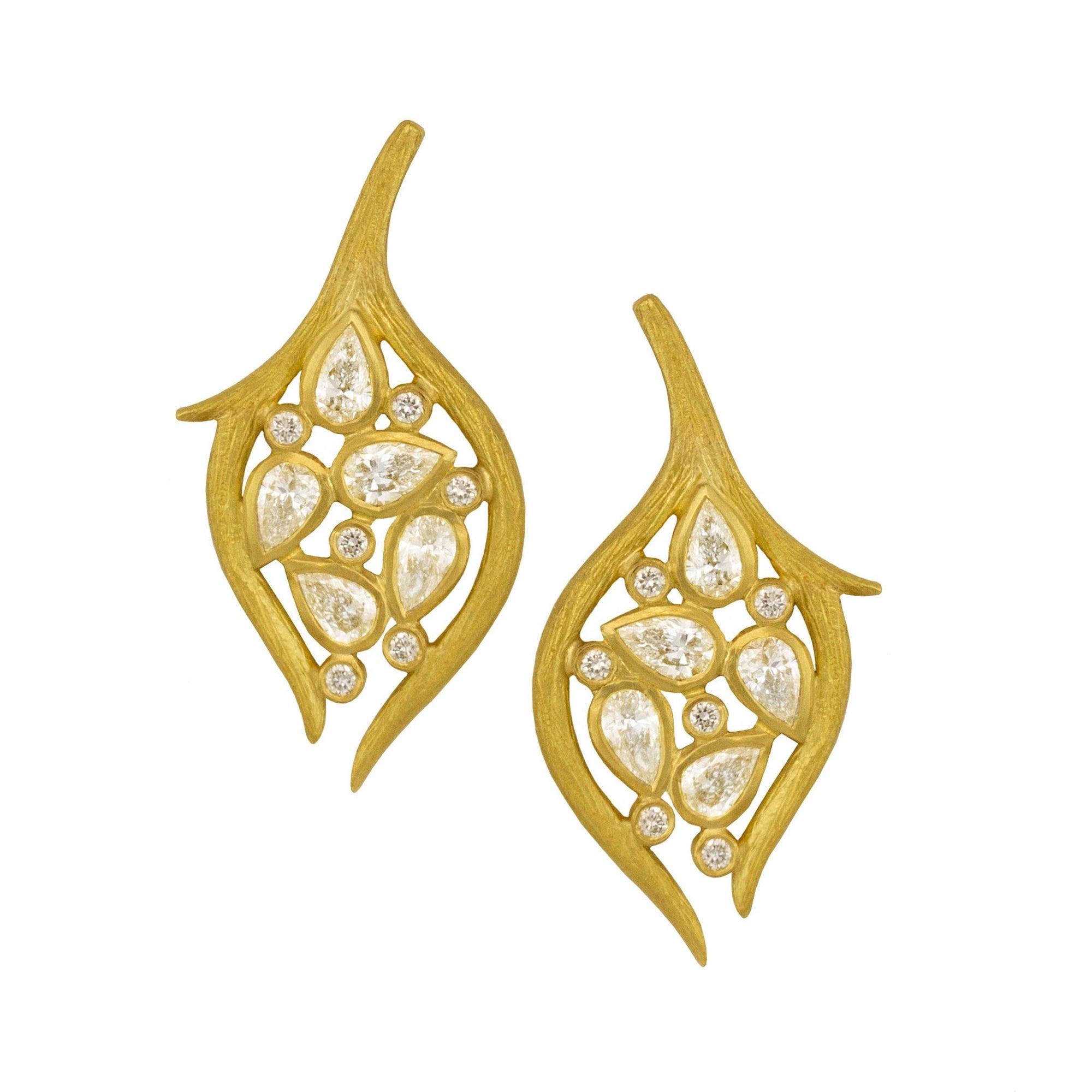 Diamond Leaf and Vine Earring by Laurie Kaiser available at Talisman Collection Fine Jewelers in El Dorado Hills, CA and online. Our 18k yellow gold Diamond Leaf and Vine Drop Earrings feature intricately textured branches embracing pear-shaped and round brilliant diamonds, resulting in a graceful leaf-inspired design. With a 1.04 cts of pear diamonds and 0.12 cts of round brilliant diamonds, these classic post back earrings are a luxurious addition to your jewelry collection.