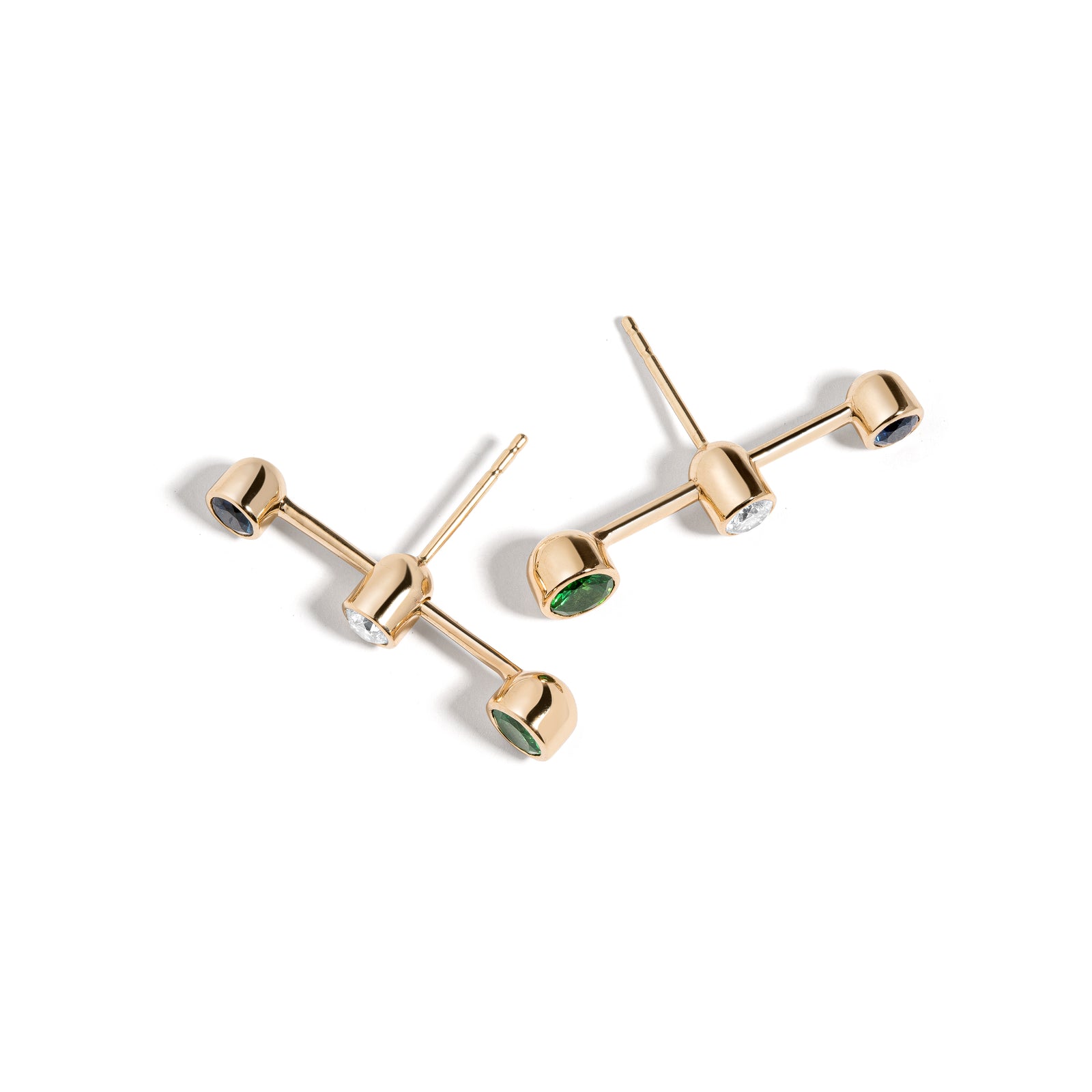 Confetti Reverse Earrings by Mined + Found available at Talisman Collection Fine Jewelers in El Dorado Hills, CA and online.  Representative of a segment in time, the Crossroad Studs may be worn with the diamond positioned close to either end cap, or centered in the middle. With 0.17 cts of diamonds and .13 cts of sapphires & tsavorite garnet, these 14k yellow gold earrings make a delicate statement for a primary piercing, and are so streamlined that they're easily worn in secondary and cartilage piercings 