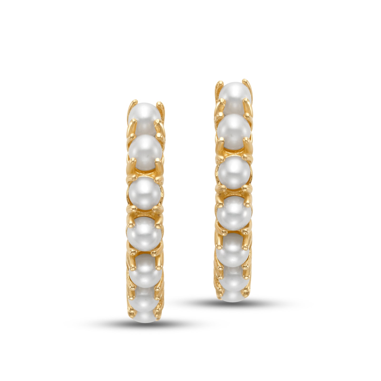 Freshwater Pearl Hoop Earrings by Mastoloni available at Talisman Collection Fine Jewelers in El Dorado Hills, CA and online. Dainty and classic, these small 14k yellow gold hoops are encircled by a row of 3mm prong-set freshwater pearls. The pearls add a soft glow that contrasts the gold, creating a delicate balance of texture and shine. Lightweight and versatile, these hoops are perfect for adding a touch of charm to both casual and dressed-up looks.
