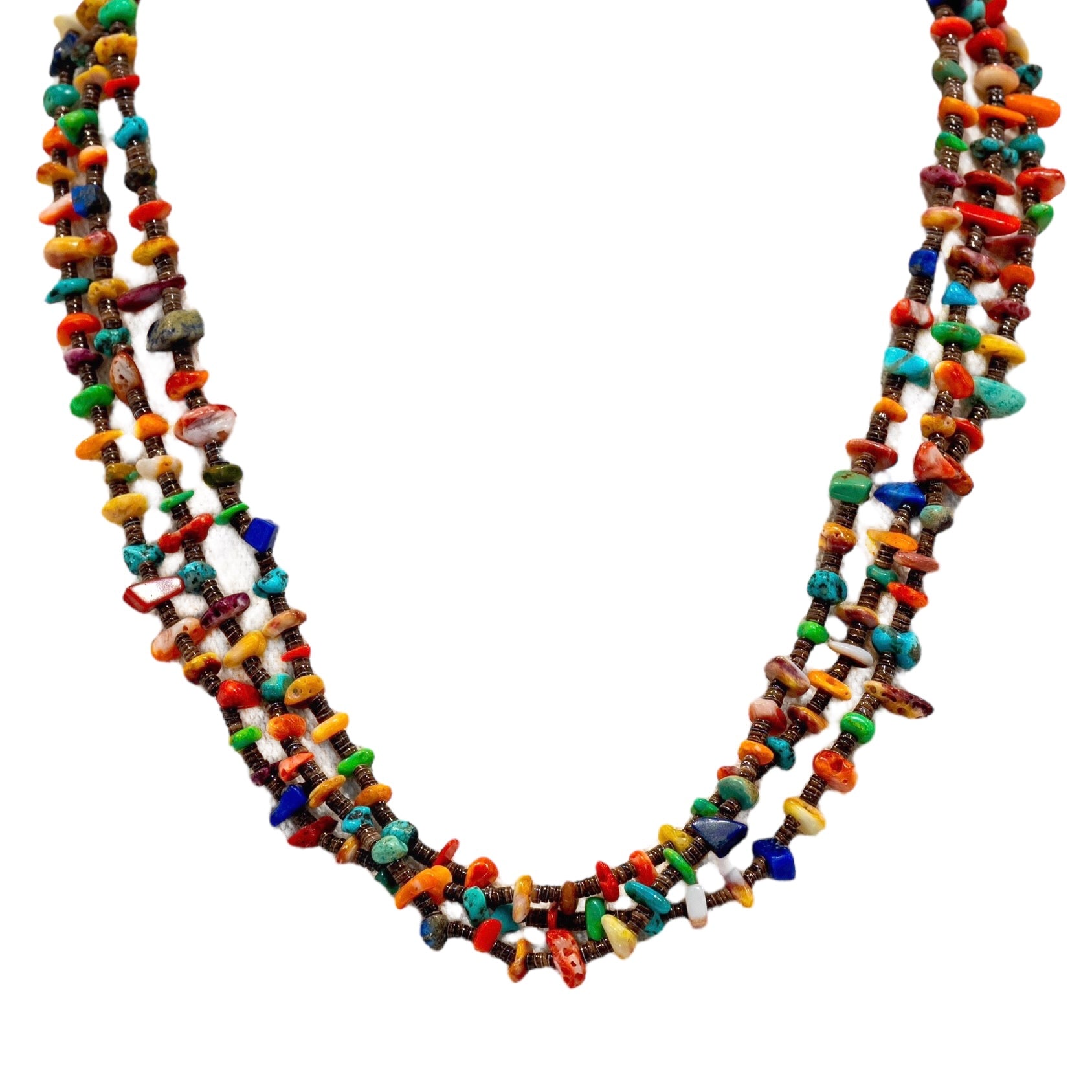 Native American 3 Strand Heishi Necklace available at Talisman Collection Fine Jewelers in El Dorado Hills, CA and online. This exquisite 3-strand necklace, measuring 18 inches in length, is a true representation of Native American artistry. Composed of baby brown olive heishi, accented with vibrant turquoise, lapis, and spiny oyster shell in four stunning shades, it exudes a sense of cultural authenticity and luxurious exclusivity