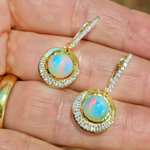 Blue Hour Opal Dangle Earrings by Martha Seely available at Talisman Collection Fine Jewelers in El Dorado Hills, CA and online. Stats: Lovely Blue Hour Dangle Earrings, crafted from 14k yellow gold and designed to dazzle with precious Welo opals, London blue topaz, and sparkling diamonds totaling 0.462 carats. These earrings are sure to take your style to new heights.