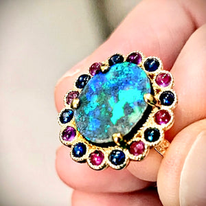Boulder Opal Ring by Martha Seely available at Talisman Collection Fine Jewelers in El Dorado Hills, CA and online. Stats: Talk about making a statement! This one-of-a-kind ring showcases a 14x12 mm boulder opal surrounded by sapphires and amethyst cabochons. A truly spectacular specimen of nature set in 14k gold. Size 7.2