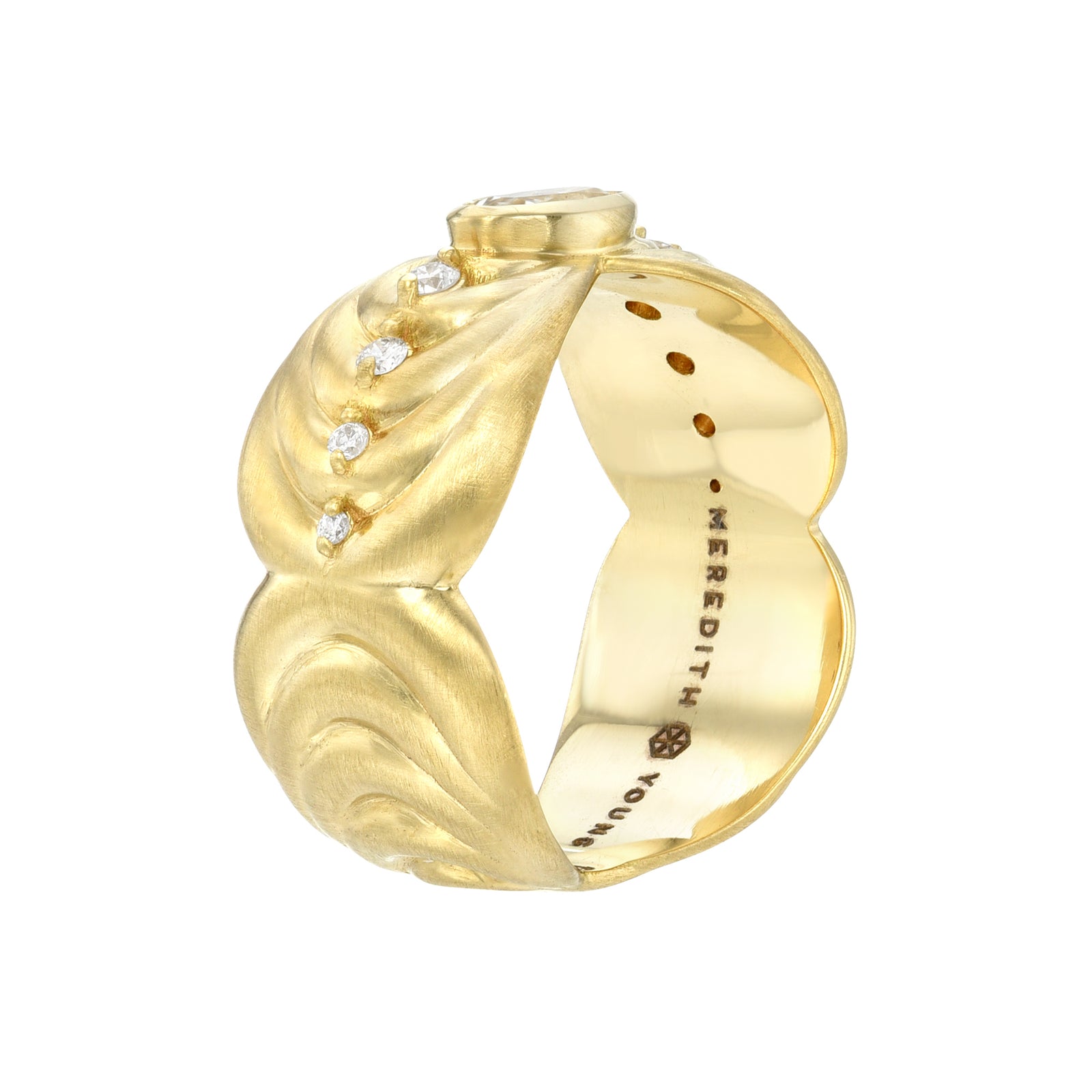 Supernova Diamond Band by Meredith Young available at Talisman Collection Fine Jewelers in El Dorado Hills, CA and online.  Behold the Supernova Diamond Band, a striking contemporary piece. A dazzling .5ct oval-cut white sapphire takes center stage, flanked by bold concentric bands of 18k gold, accented with .15 carats of round brilliant diamonds. This ring marries modern aesthetics with sculptural appeal, making it a true standout.