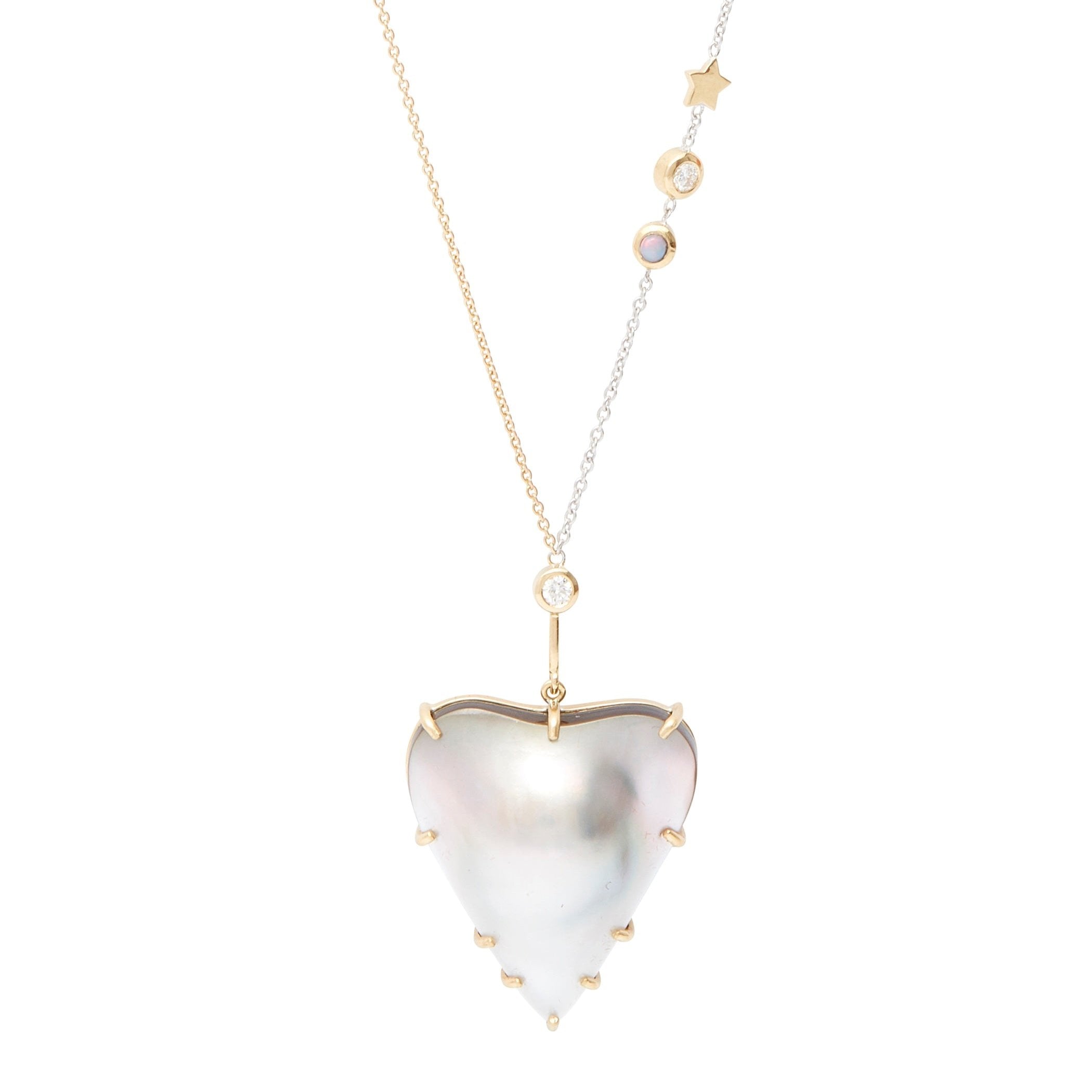 Beam Mabe Pearl Necklace by Unhada available at Talisman Collection Fine Jewelers in El Dorado Hills, CA and online. The Beam Necklace showcases a heart-shaped mabe pearl, set against a two-tone chain that’s asymmetrically embellished with a bezel-set opal, a diamond, and a tiny gold star. Crafted from 18k gold and sterling silver, this one-of-a-kind creation features an adjustable length of 18-22” and is secured with a lobster clasp. Its distinctive design and exceptional craftsmanship make it a truly uniq