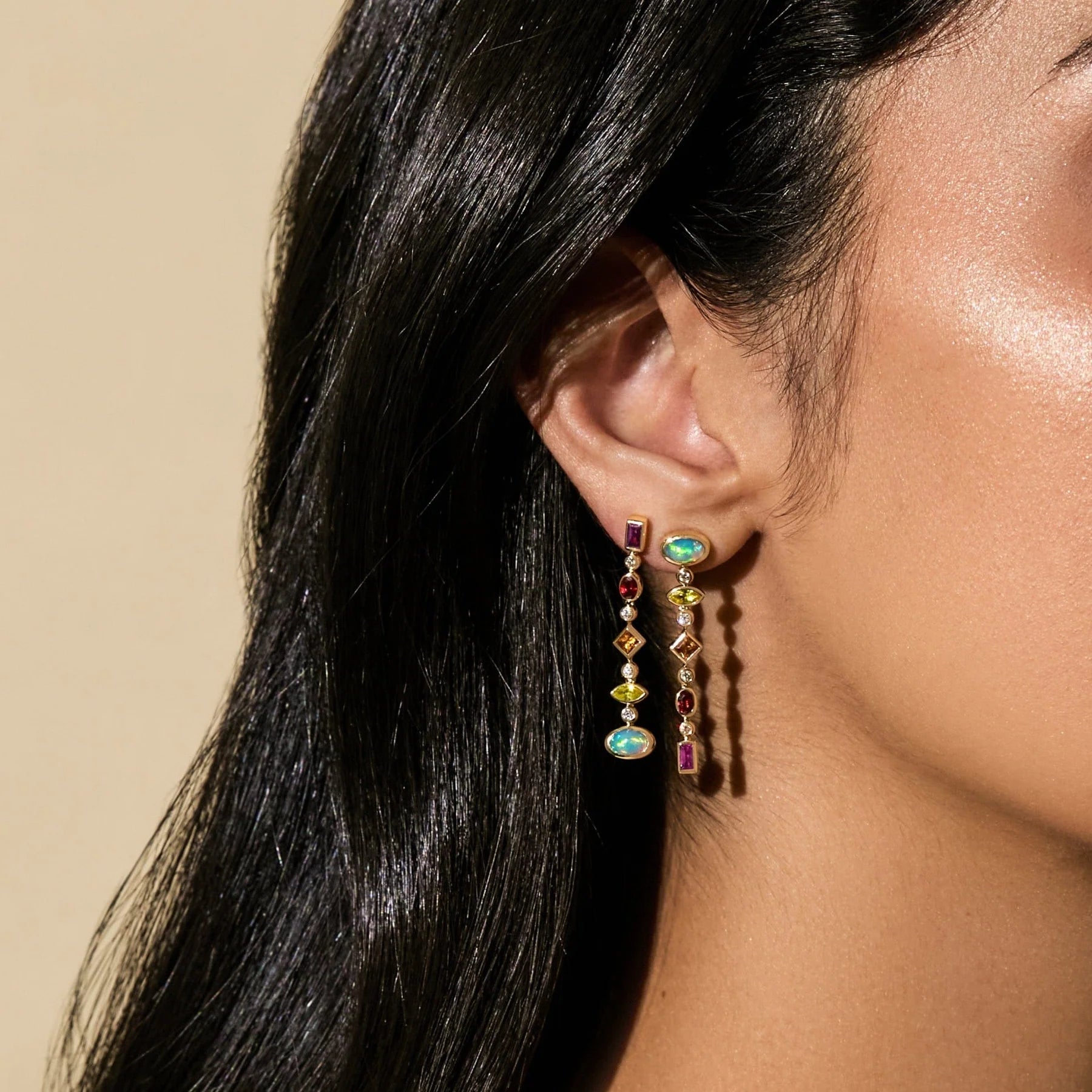 Confetti Reverse Earrings by Mined + Found available at Talisman Collection Fine Jewelers in El Dorado Hills, CA and online. These festive earrings features a cool ombré gradient of  of brilliant gems including: tsavorite garnet, amethyst and blue topaz paired with moonstone, rich with blue flashes of adularescence, totaling 2.22 cts combined. The handmade 14k yellow gold settings are accented with 0.17cts of sparkling diamonds. And the Confetti Convertible earrings hold a secret: a hinged post at each end 