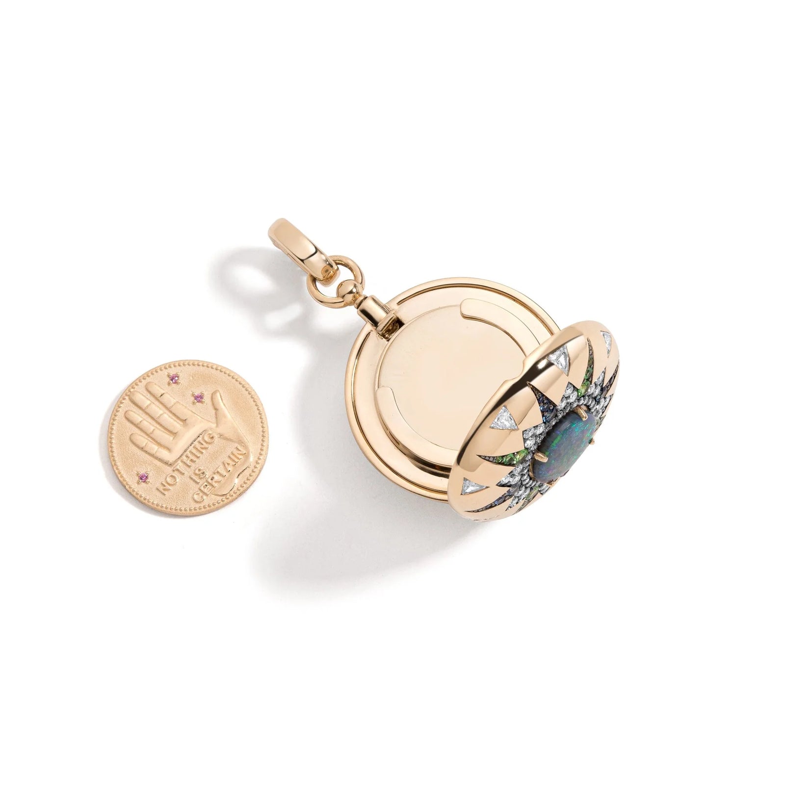 Direction Major Australian Opal Locket by Mined + Found available at Talisman Collection Fine Jewelers in El Dorado Hills, CA and online. Direction Major is decorated with an antique compass rose inspired motif centering a 1.50ct Lightning Ridge Australian black opal, .41 cts of blue sapphire and tsavorite garnet, and 1.27 cts of diamond trillions. The enhancer bail opens at back to allow Direction to adorn large link, pendant, and beaded chains alike and is finished with a safety clasp. Pendant only, no ch