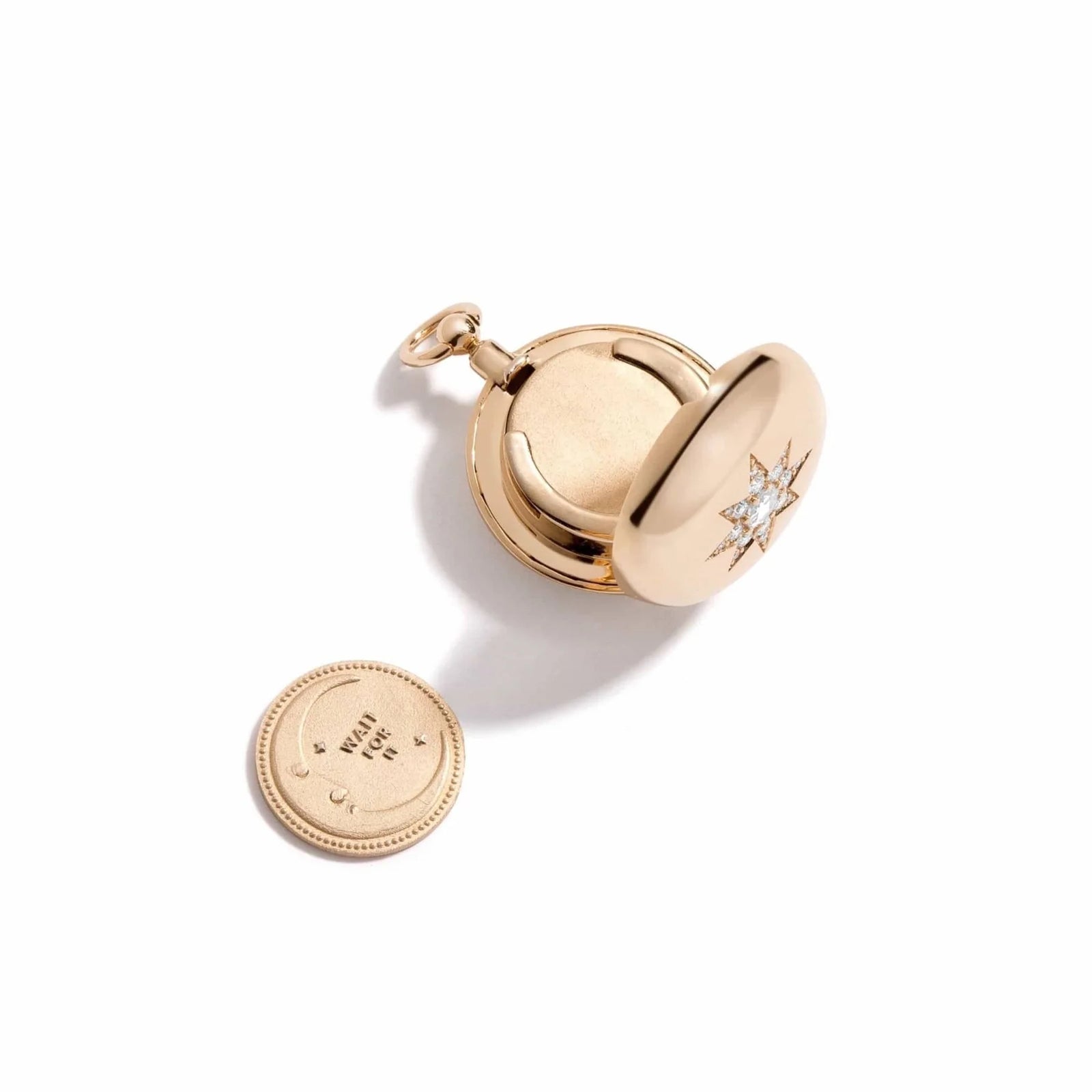 Direction Diamond Locket by Mined + Found available at Talisman Collection Fine Jewelers in El Dorado Hills, CA and online. Capture attention, touch the soul, ignite chatter and offer meaningful embellishment - this extraordinary locket is a stunning illustration. Within the 14k gold locket, a coin peeks out in a sleek, velvety finish.On the one side, a sunburst dictates "GO FOR IT." The reverse, a serene moonscape, with the message "WAIT FOR IT."&nbsp; Direction Major is decorated with an antique compass r