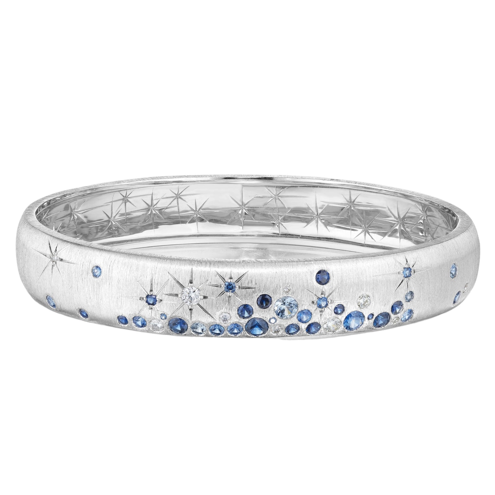 Sapphire Galaxy Bangle by Penny Preville available at Talisman Collection Fine Jewelers in El Dorado Hills, CA and online. This bangle is the epitome of celestial style, boasting beautiful blue sapphires and diamonds that twinkle like stars set against 18k white gold.