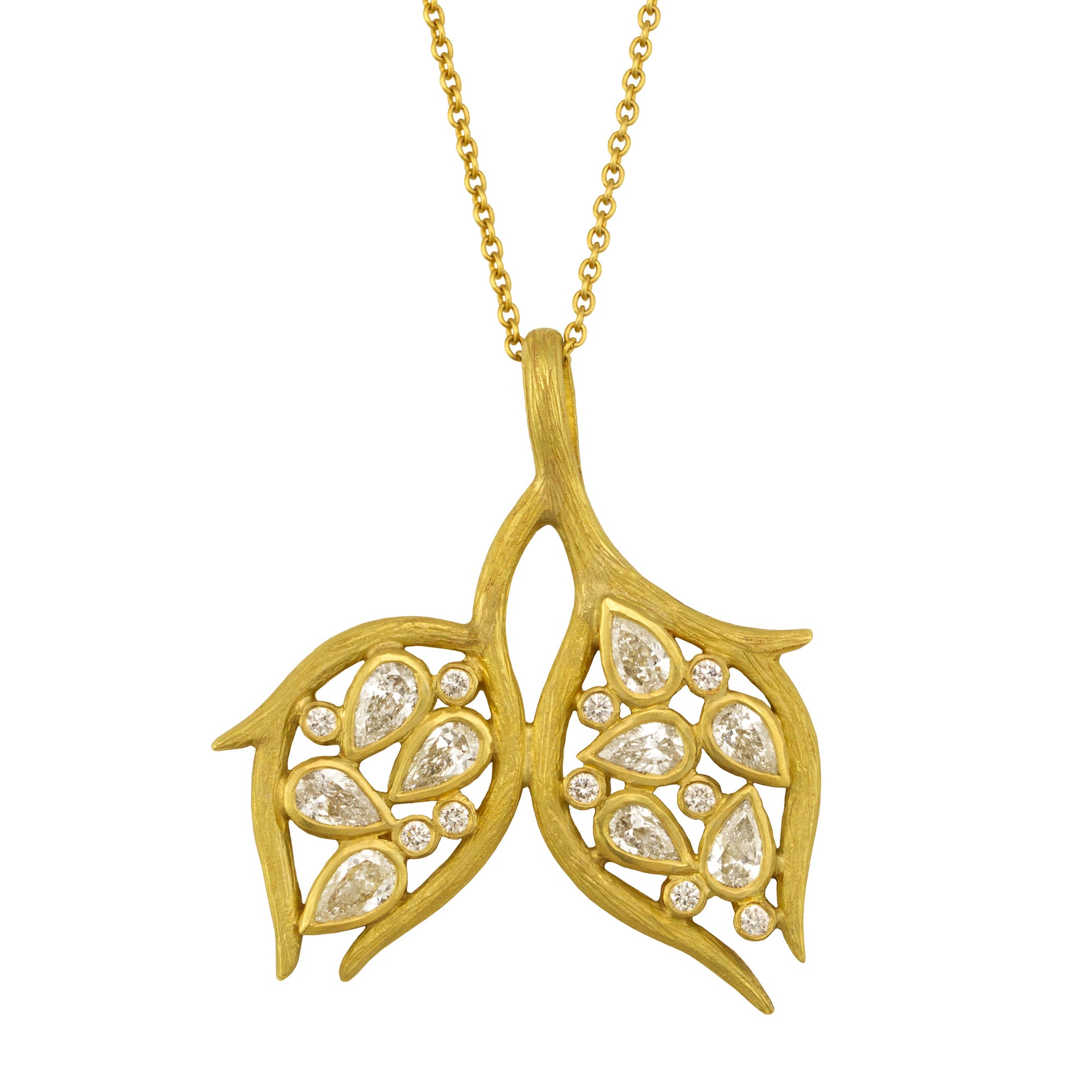 Double Leaf and Vine Pendant Necklace by Laurie Kaiser available at Talisman Collection Fine Jewelers in El Dorado Hills, CA and online.The Double Leaf and Vine Pendant Necklace embodies the beauty of nature. The pendant is embellished with glistening pear-cut diamonds totaling .90 carats and .10cts of white round brilliant diamonds all set in 18k yellow gold subtly textured vines. The 20-inch chain makes it a perfect choice for layering, or worn alone, it highlights your décolletage.