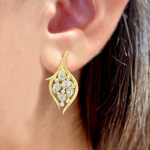 Diamond Leaf and Vine Earring by Laurie Kaiser available at Talisman Collection Fine Jewelers in El Dorado Hills, CA and online. Our 18k yellow gold Diamond Leaf and Vine Drop Earrings feature intricately textured branches embracing pear-shaped and round brilliant diamonds, resulting in a graceful leaf-inspired design. With a 1.04 cts of pear diamonds and 0.12 cts of round brilliant diamonds, these classic post back earrings are a luxurious addition to your jewelry collection.
