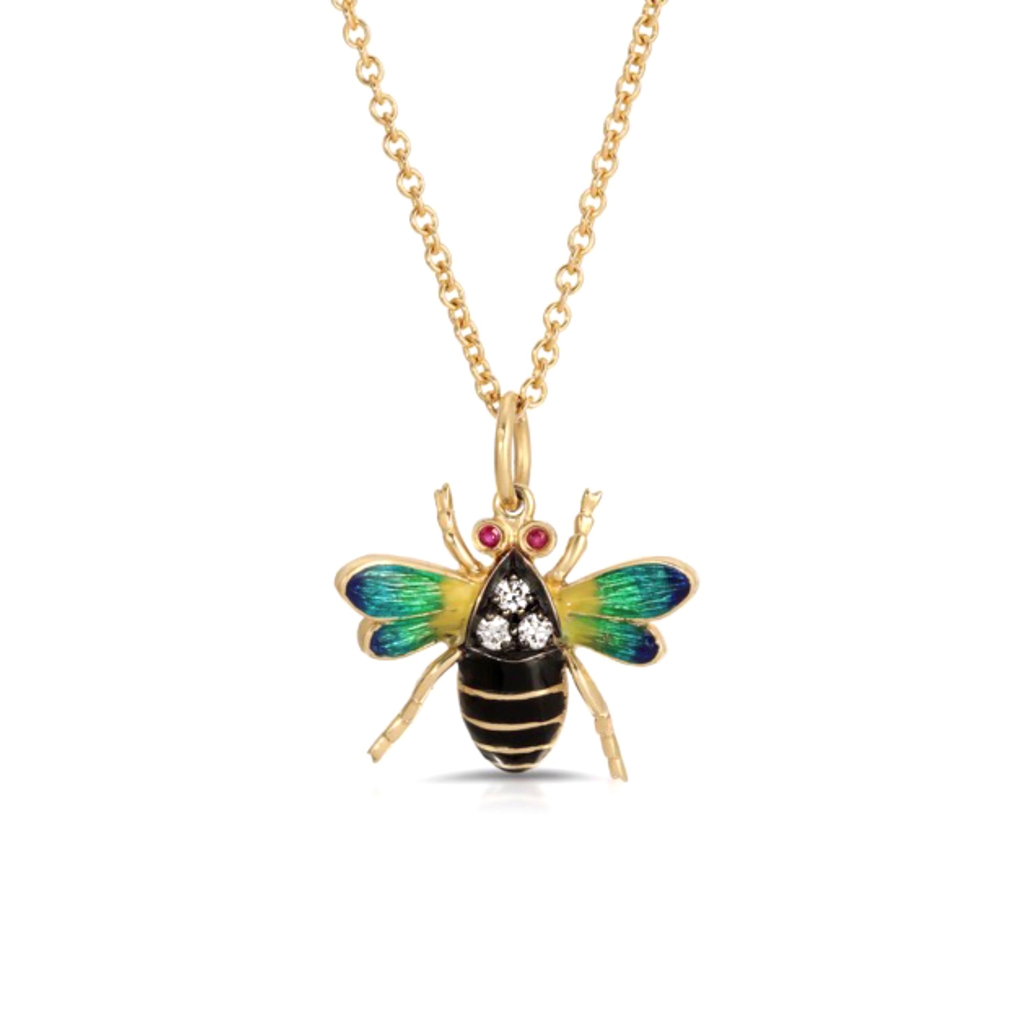 Enamel Bumble Bee Pendant Necklace by Lord Jewelry available at Talisman Collection Fine Jewelers in El Dorado Hills, CA and online. A classic and often preppy motif, this delightful 18k enamel bumble bee necklace features ombre blue-green enamel wings and is accented with 0.15 carats of diamonds and 0.05 carats of rubies for a touch of sparkle. Worn alone or layered, this sweet necklace will add a playful pop of color to your look.