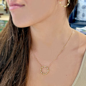 Meet the Open Circle Energy Necklace by Meredith Young, available at Talisman Collection Fine Jewelers in El Dorado Hills, CA and online. ! This lovely piece showcases a playful arrangement of .56 cts of white princess diamonds, dancing alongside 18k gold triangles. The pendant's diameter extends to over 1 inch, and it offers an adjustable length, so you can wear it comfortably at 16 to 18 inches. It's a perfect choice for adding a touch of sparkle to any day.