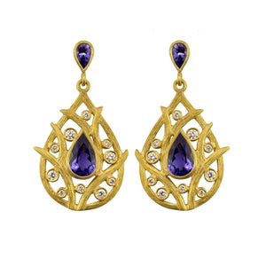 Vine Tanzanite Earrings by Laurie Kaiser available at Talisman Collection Fine Jewelers in El Dorado Hills, CA and online. Featuring pear-cut faceted tanzanites surrounded by 18k yellow gold vines and accented with 0.31 cts of white brilliant diamonds, these earrings are sure to make a statement. The secure post backs ensure comfortable and worry-free wear. You'll cherish these stunners for years to come.