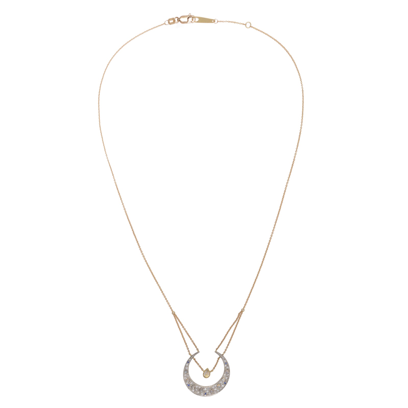 Sapphire & Diamond Selene Necklace by Unhada available at Talisman Collection in El Dorado Hills, CA and online. The Selene diamond moon necklace is aptly named after the Greek goddess and features a sterling silver pending encrusted with .34 cts of diamonds, complemented by blue sapphires and faceted rainbow moonstones. Adding to its elegance, a single pear-cut labradorite rests in the center of the crescent, suspended from an 18k yellow gold chain. The necklace can be adjusted to a length of 16 – 18”