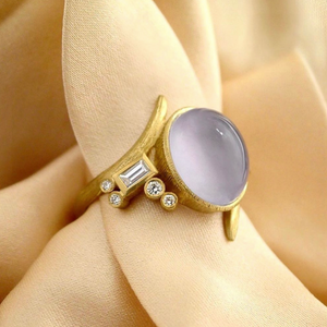 Lavender Chalcedony Vine Ring by Laurie Kaiser available at Talisman Collection Fine Jewelers in El Dorado Hills, CA and online. Made from 18k yellow gold, it features a luminescent lavender chalcedony stone that's accented with 0.18 carats of white brilliant-cut and baguette diamonds, giving it an extra sparkle. The unique vine design adds an air of sophistication to the ring making it a piece you'll treasure forever.