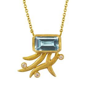 Sky Blue Topaz Breezy Vines Necklace by Laurie Kaiser available at Talisman Collection Fine Jewelers in El Dorado Hills, CA and online. The necklace features a stunning emerald cut sky blue topaz set in 18k yellow gold and delicate trailing vines accented with 0.06 cts of white diamonds. The necklace is 17" long, making it the perfect length to wear with a variety of necklines.