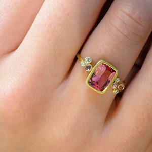 Pink Sprinkles Ring by Laurie Kaiser available at Talisman Collection Fine Jewelers in El Dorado Hills, CA and online. An emerald cut Brazilian pink fluorite takes center stage in the Pink Sprinkles Ring, while white diamonds (0.06 cts) and pink sapphires (0.10 cts) delicately frame the stone. Set in 18k yellow gold, this ring is perfect for adding a pop of color to any outfit.
