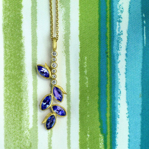 Tanzanite Vine Bar Necklace by Laurie Kaiser available at Talisman Collection Fine Jewelers in El Dorado Hills, CA and online. The modern, linear design of the Tanzanite Vine Bar Necklace is accented with dazzling tanzanites and .08 cts of white brilliant diamonds set in 18k yellow gold. With a 19" chain, it's a perfect length to layer. This special piece is sure to become a cherished addition to your jewelry box.